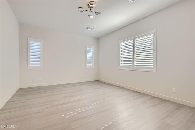 unfurnished room with light wood-type flooring