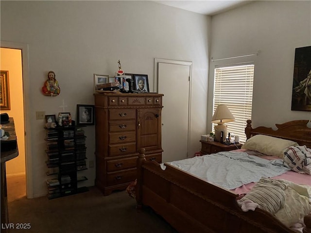 bedroom with dark carpet