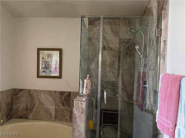 bathroom with shower with separate bathtub