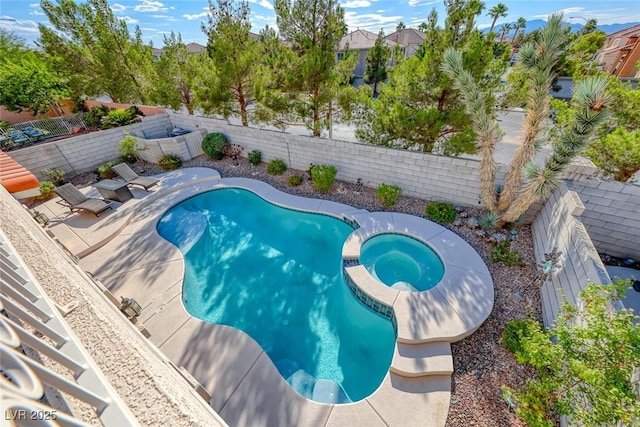 view of pool with an in ground hot tub and a patio