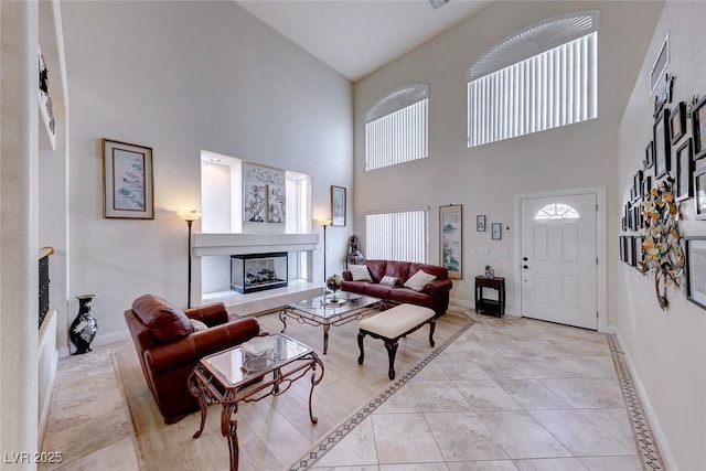 tiled living room featuring a towering ceiling