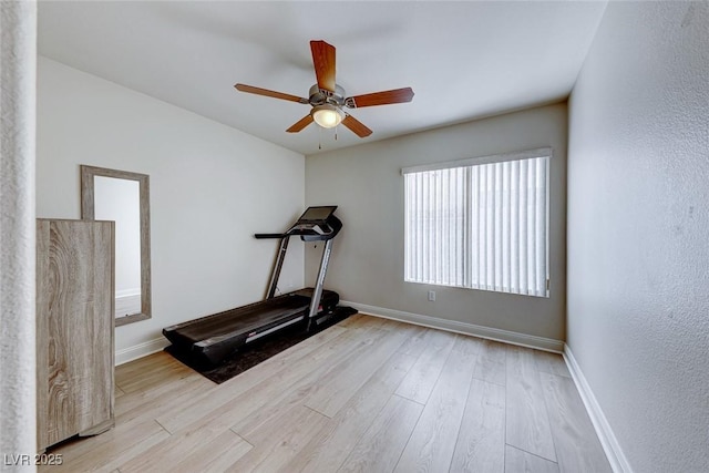 exercise room featuring ceiling fan and light hardwood / wood-style floors