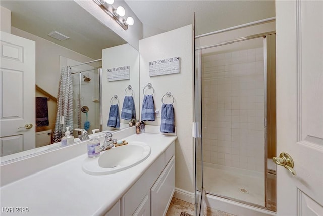 bathroom featuring tile patterned flooring, vanity, and a shower with shower door