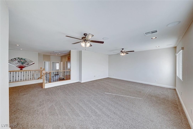 carpeted spare room with ceiling fan