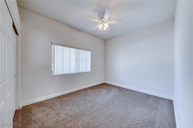 carpeted spare room with ceiling fan