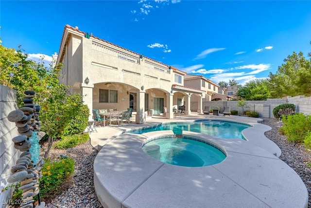 view of swimming pool with a patio area and an in ground hot tub