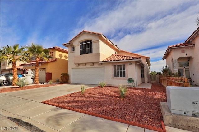 mediterranean / spanish-style house with a garage