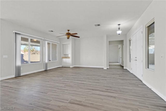 unfurnished room featuring ceiling fan and light wood-type flooring