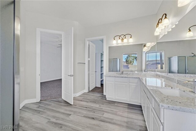 bathroom with vanity, hardwood / wood-style flooring, and walk in shower