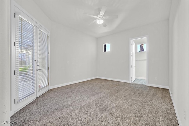 carpeted spare room with ceiling fan