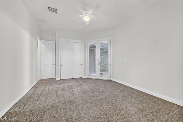 empty room featuring ceiling fan and carpet floors