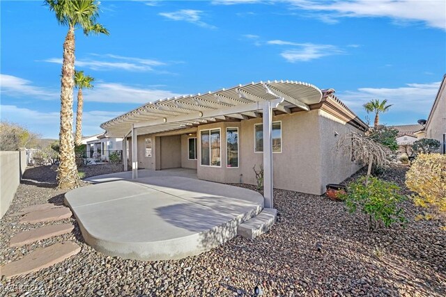 back of house with a pergola and a patio area