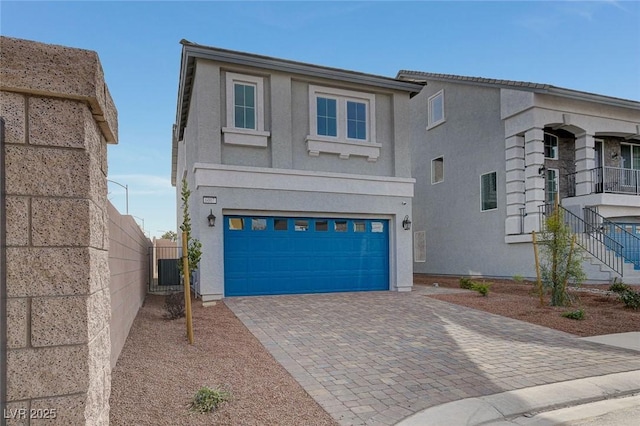 front facade featuring a garage and central AC unit