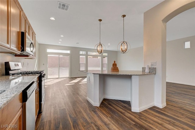 kitchen featuring dishwashing machine, range with gas cooktop, light stone countertops, and dark hardwood / wood-style floors