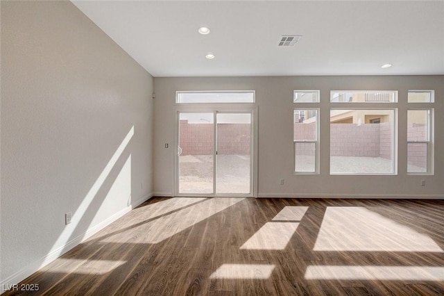 spare room with wood-type flooring