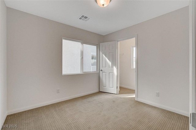 empty room featuring light colored carpet