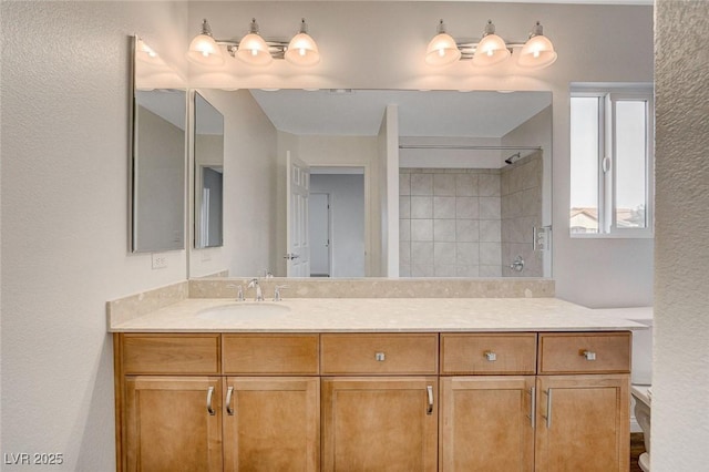 bathroom featuring vanity and a shower