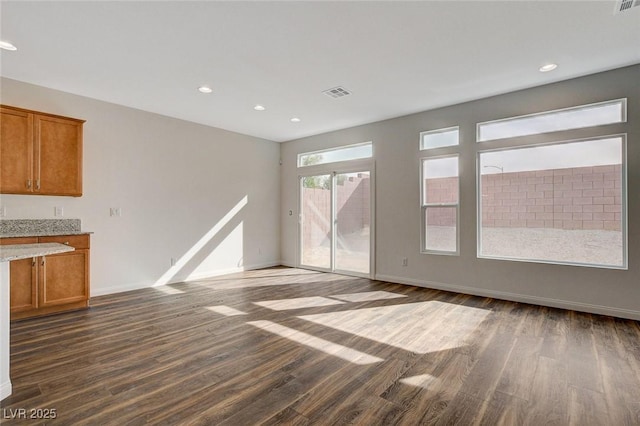 unfurnished living room with dark hardwood / wood-style floors