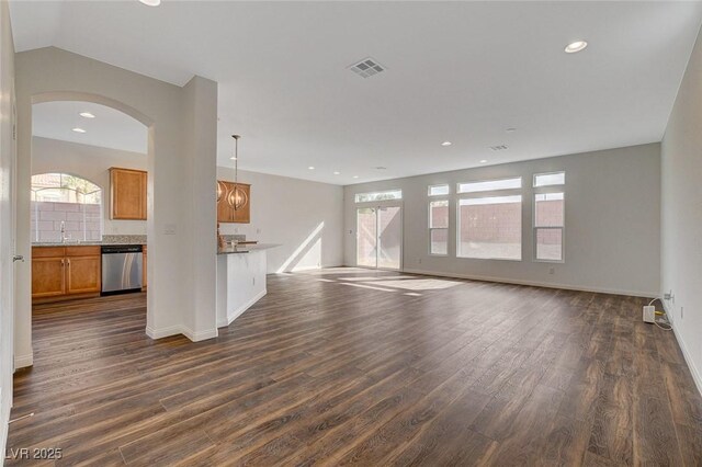 unfurnished living room featuring dark hardwood / wood-style flooring and sink