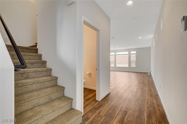 stairway featuring wood-type flooring