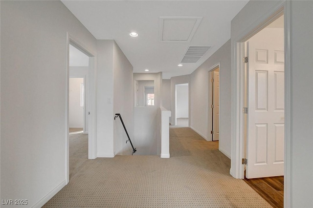 hall featuring light colored carpet