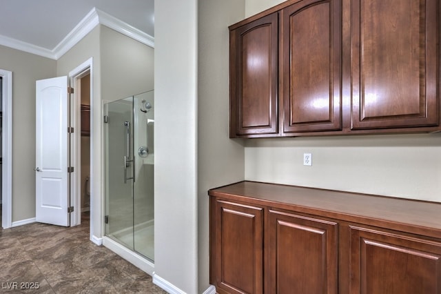 bathroom featuring an enclosed shower and ornamental molding