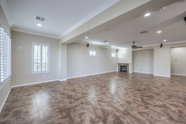 unfurnished living room with ceiling fan, a premium fireplace, and ornamental molding