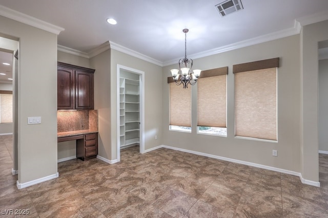 unfurnished dining area featuring crown molding, built in desk, and an inviting chandelier