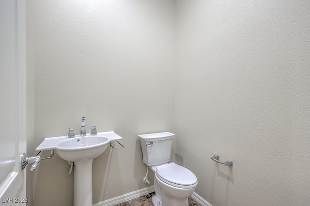 bathroom featuring toilet