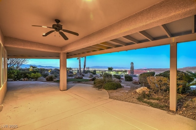 view of patio / terrace featuring a mountain view and ceiling fan