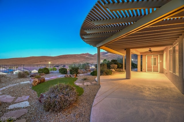 view of yard with a pergola, a patio area, a mountain view, and ceiling fan