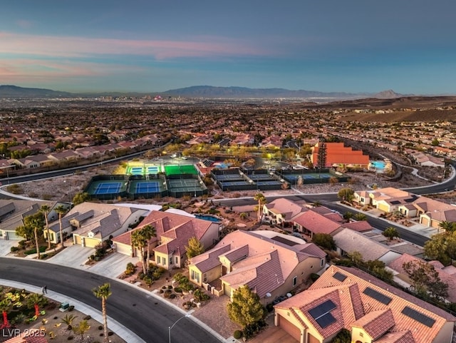 aerial view at dusk featuring a mountain view