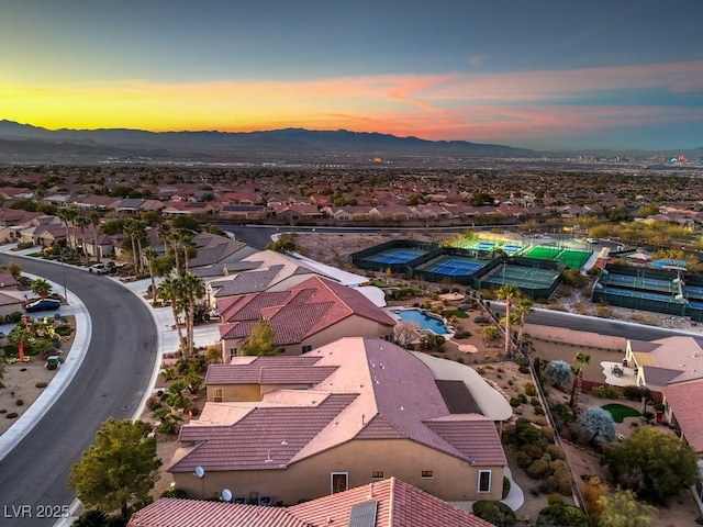 aerial view at dusk featuring a mountain view