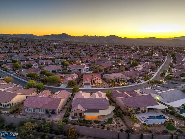 aerial view at dusk featuring a mountain view