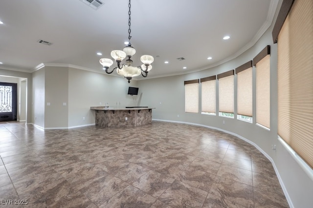 unfurnished living room with a wealth of natural light, ornamental molding, and a notable chandelier