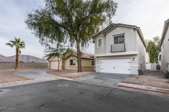 view of front facade featuring a mountain view and a garage