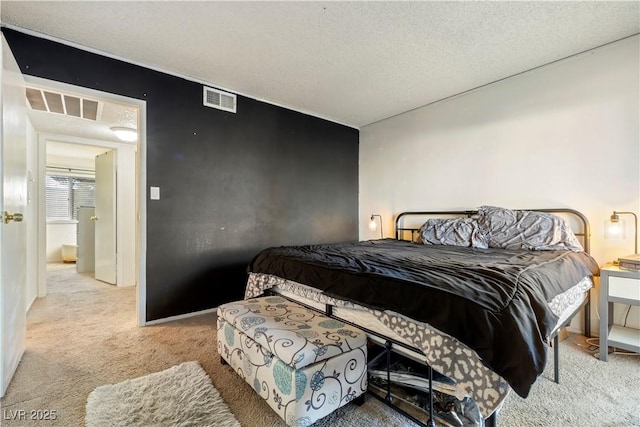 bedroom featuring light carpet and a textured ceiling