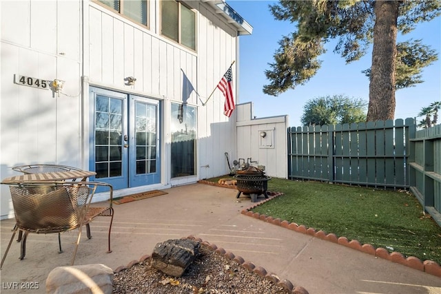 view of patio with french doors and an outdoor fire pit