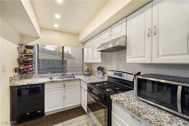 kitchen with light stone countertops, stainless steel appliances, sink, light tile patterned floors, and white cabinets