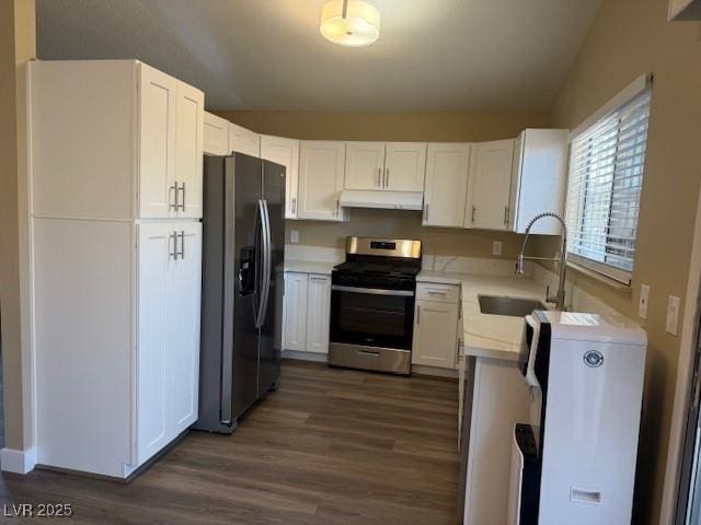 kitchen with white cabinetry, sink, dark wood-type flooring, vaulted ceiling, and appliances with stainless steel finishes