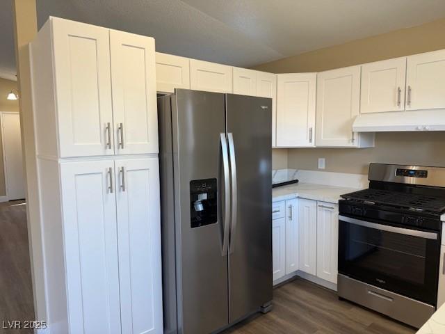 kitchen featuring dark hardwood / wood-style flooring, white cabinets, and stainless steel appliances