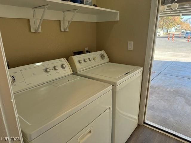 clothes washing area with washer and clothes dryer