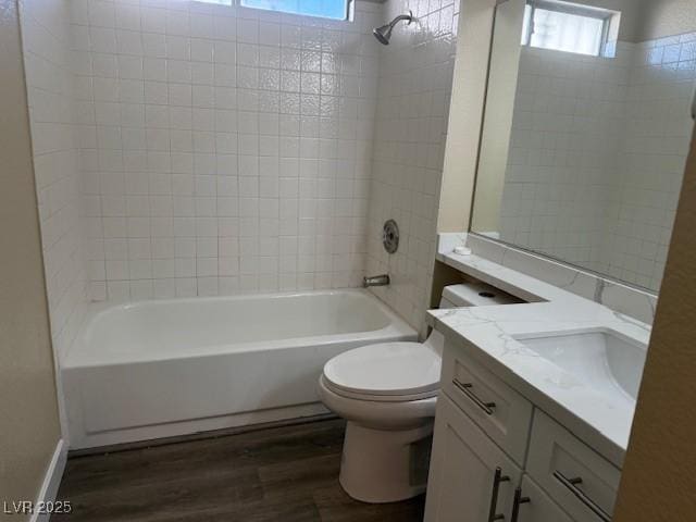 full bathroom featuring shower / bath combination, vanity, wood-type flooring, and toilet