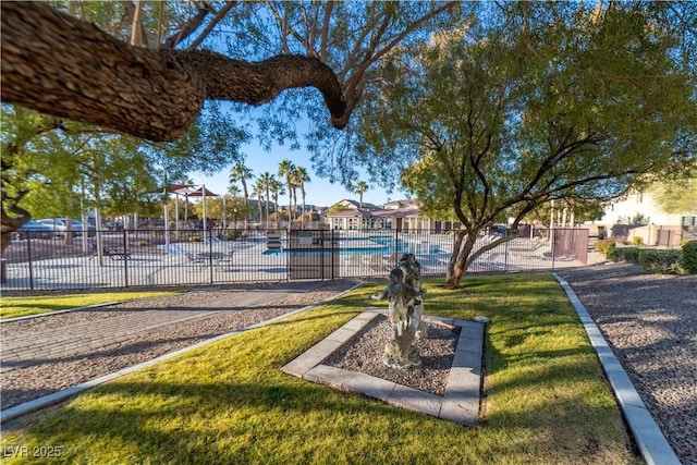 view of home's community with a swimming pool and a lawn