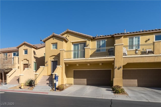 multi unit property with a garage and a balcony