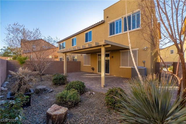 rear view of property featuring central AC and a patio area