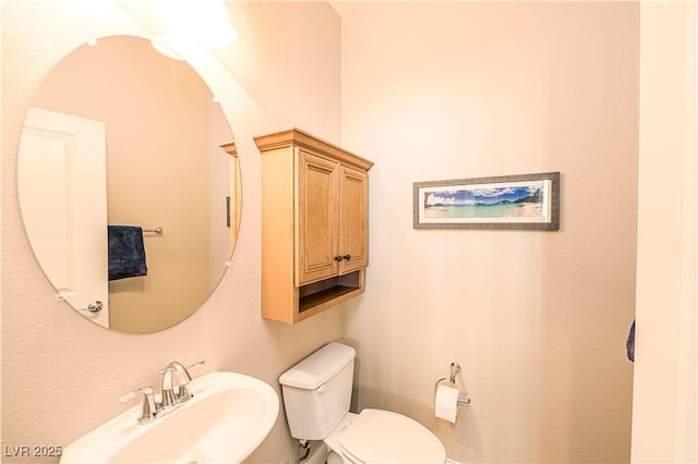 bathroom featuring sink and toilet