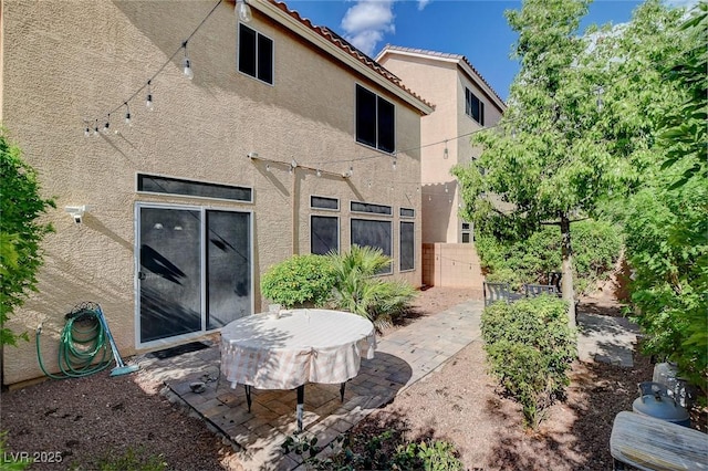 back of house with a patio