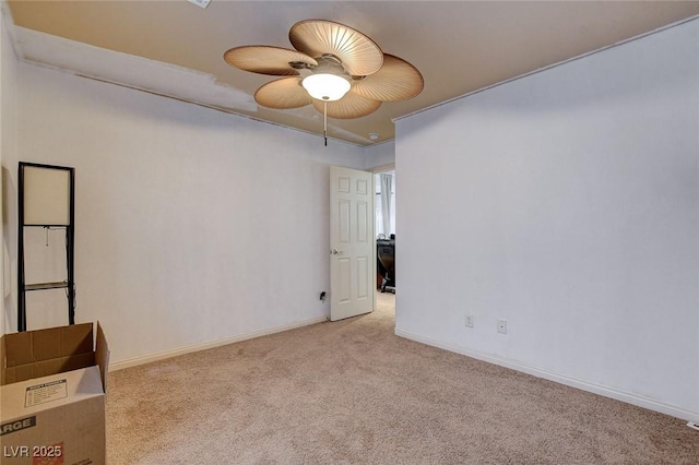 unfurnished room featuring light carpet and ceiling fan