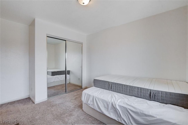 bedroom with light carpet and a closet